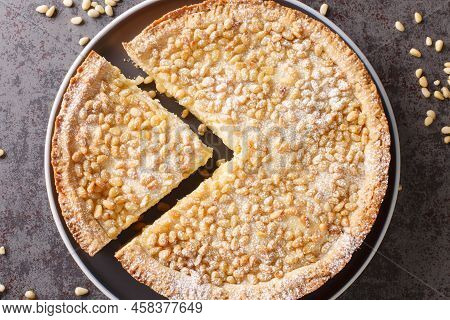 Italian Grandma's Pie With Custard And Pine Nuts Close-up In A Plate On The Table. Horizontal Top Vi
