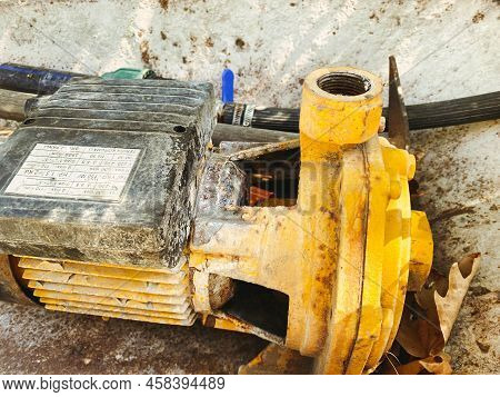 A Piece Of Yellow Metal Reinforcement Lies On The Ground. Metal Piece For Construction And Erection 
