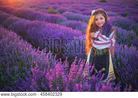 Girl With Traditional Folklotr Bulgarian Dress In Field Field