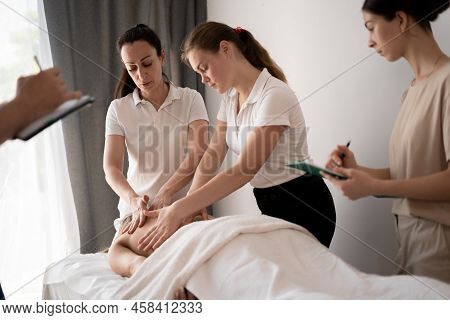 Woman Teacher Helping Students Become A Masseuse, Wellness Massage Training