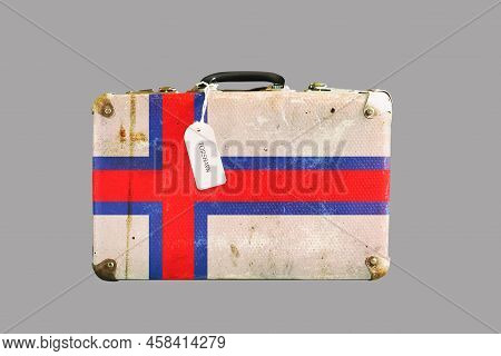 Old Suitcase In The Colors Of The Faroe Island Flag. Isolated On Gray Background. Travels. Signs And