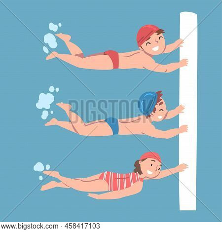 Kids Learning To Swim In Swimming Pool. Boys And Girl In Swimwear, Caps And Goggles Practicing Skill