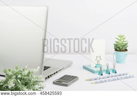 Lap Top, Pencils, Calculator, Paperclips, Flowers And Sticky Notes Placed On Desk. Computer, Pens, C