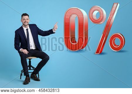 Handsome Man Pointing At Sign Zero Percent On Light Blue Background. Special Promotion