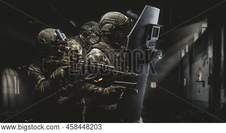 Armed Group Of Special Forces Against The Background Of A Destroyed Building. The Concept Of Game Si