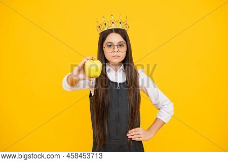 Teen Child In Queen Crown Hold Apple Isolated On Yellow Background. Princess Girl In Tiara. Teenage 