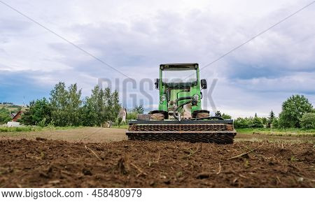 Mini Skid Steer Loader Clear The Construction Site. Land Work By The Territory Improvement. Small Tr