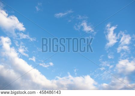 Blue Sky Background With White Fluffy Cumulus Clouds. Panorama Of White Fluffy Clouds In The Blue Sk