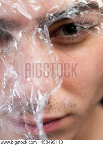 Health Care. Man Transparent Piece Of Plastic Surrounded His Head. Ecology Danger. Plastic Recycle R