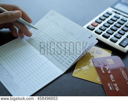 Finger Holding Pen Poin Number On Book Bank With Caculator Credit Card Plan Investment Income For 20