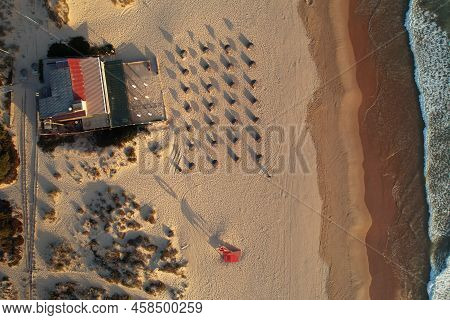 Top Down Drone View Of Beach Bar On Coastline At Costa Caparica, Portugal. Aerial Shot On Minimalist