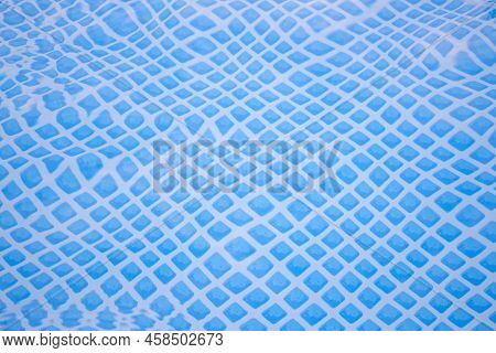 Blue Ripped Water In A Swimming Pool In Summer For A Background. Relaxation Pattern.