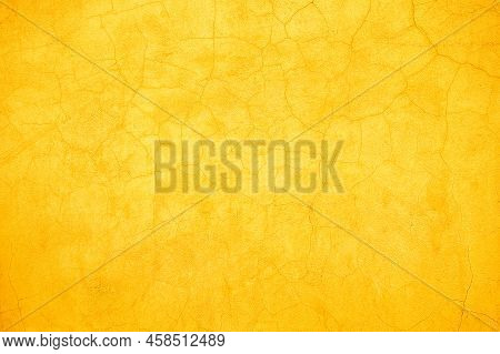 Abstract Rustic Yellow And Orange Cracked Wall Background Texture Design.