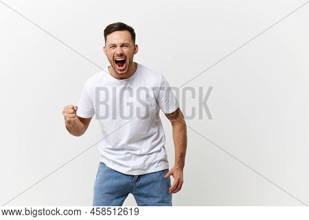 Abusive Relationships Concept. Aggressive Angry Crazy Handsome Man In Basic T-shirt Scream Swings Fi