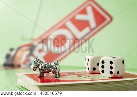 Kaunas, Lithuania - July 2022: Monopoly Dog, Monopoly Board And Dices On The Monopoly Chance Cards.
