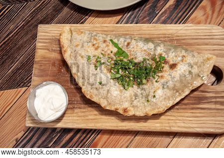 Still Life With Food: Kutaba On A Wooden Board And A Bowl With Sour Cream