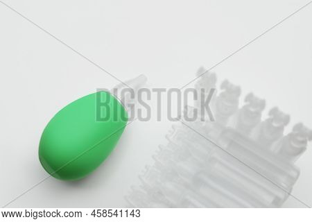 Single Dose Ampoules Of Sterile Isotonic Sea Water Solution And Nasal Aspirator On White Background,