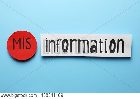 Word Misinformation Made With Paper Pieces On Light Blue Background, Flat Lay