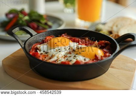 Tasty Shakshouka Served On White Table, Closeup. Traditional Arabic Dish