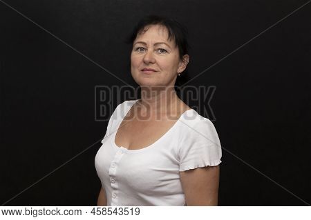 Portrait Of An Elderly Brunette Woman 50-55 Years Old On A Dark Background 55.