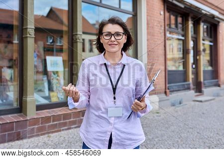 Woman Art Gallery Worker Standing Near Glass Showcase Of Outdoor Art Store