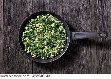 Spanakorizo, Greek Spinach And Rice Pilaf With Lemon, Dill, Spring Onion On A Pan On Dark Wooden Tab