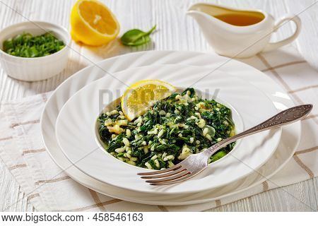 Spanakorizo, Greek Spinach And Rice Pilaf With Lemon, Dill, Spring Onion In White Bowl With Fork On 