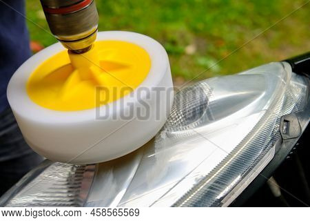 Hands Of A Professional Car Service Male Worker With Orbital Polishing Machine