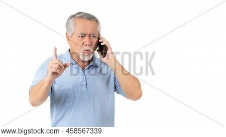 Asian Senior Man , Old Man Was Standing And Talking On The Phone With A Serious Expression On His Fa