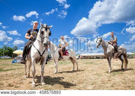 Ruma, Serbia - June 26, 2022: Selective Blur On Three Horseriders, Serbian Young Men, Riding Horses 