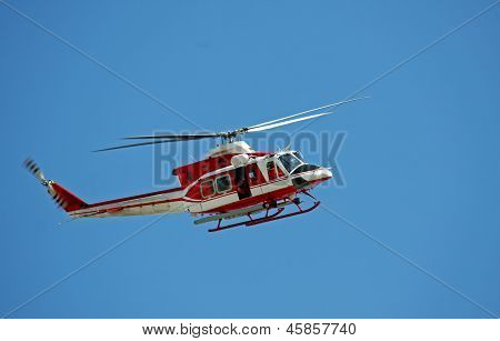 Patrol Helicopter Of Firefighters In Blue Sky Over A Fire 10