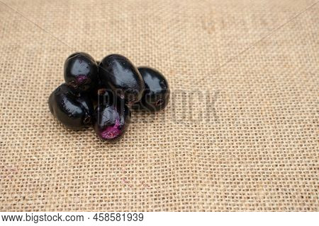 Closeup Of Malabar Plum Or Syzygium Cumini Isolated On Burlap Fabric With Copy Space, Also Known As 