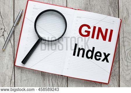 Gini Index Text On Rustic Background On Notepad