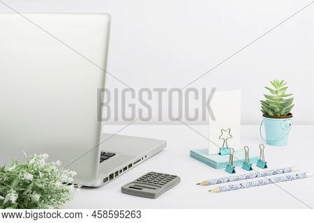 Lap Top, Pencils, Calculator, Paperclips, Flowers And Sticky Notes Placed On Desk. Computer, Pens, C