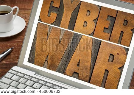 Cyber War - Words In Vintage Letterpress Wood Type On Laptop Screen, Cyberwarfare And Digital Attack
