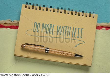 Do More With Less Productivity Concept  - Handwriting In A Spiral Notebook Against Colorful Abstract