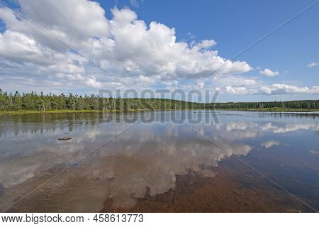 Calm Waters And Summer Clouds On Benjies Lake In Cape Breton Highlands National Park In Nova Scotia