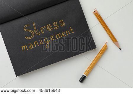Black Sketchbook With Words Stress Management And Broken Pencil On White Background, Flat Lay
