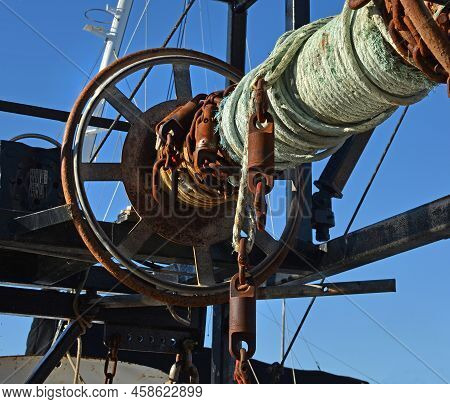 Detailed Closeup Of Rusty Old Winch And Rope On A Fishing Trawler Boat.