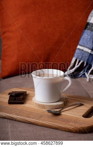Autumn Mood Composition With Cup Of Cocoa And Chocolate, Plaid And Book On Sofa Background. Hot Drin