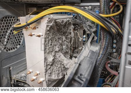 Close-up Of A Computer Cooling System Radiator Clogged With Dust And Can No Longer Cool The Processo