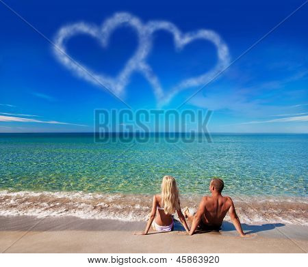 Love Concept - Young Couple On Sea Beach Look At Cloud Heart