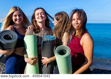 Group Of Five Women Practicing Yoga Assans In Morning Beach . Only Girls Session