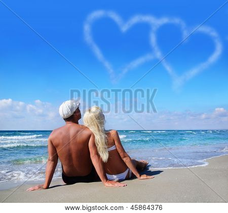Love Concept - Couple On Sea Beach Look At Cloudy Heart