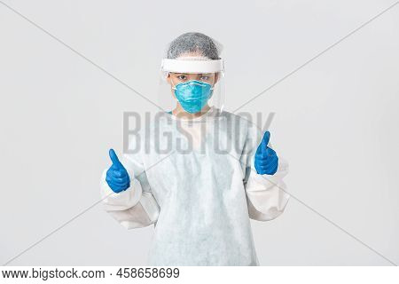 Covid-19, Coronavirus Disease, Healthcare Workers Concept. Serious-looking Confident Young Asian Fem