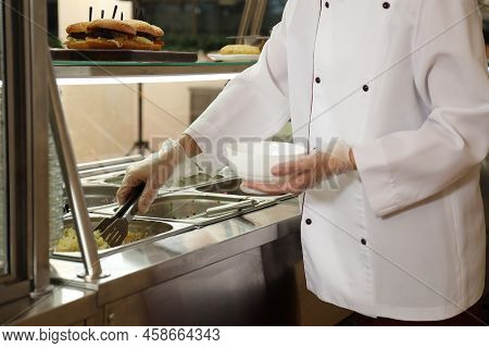 School Canteen Worker At Serving Line, Closeup. Tasty Food