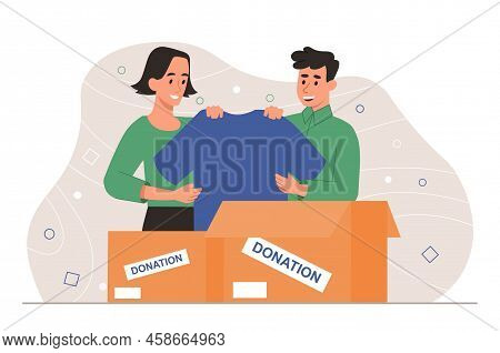 Charitable Donation Of Clothing. Smiling Guy And Girl Collect Tshirts And Put Them In Cardboard Box.