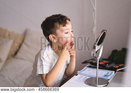 Speech Therapy Concept. Cute Little Boy Pronouncing Sound O Looking At Mirror Doing An Online Speech