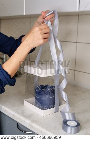 Pastry Chef Packs The Cake In A Fancy Box. Hands Of Female Bakery Chef Or Saleswoman Packing Cake In