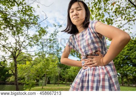Asian Little Girl Holding Belly With Her Hands,stomachache,cute Child Have Abdominal Pain,sick Woman